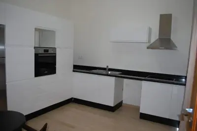 a white kitchen with a sink and a stove at Suites Appartement Midelt in Midelt