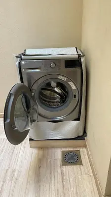 a washing machine sitting in the corner of a room at Suites Appartement Midelt in Midelt