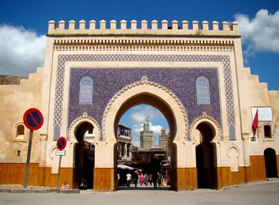 a building with an arch with a city in the background at Riad Anis Fes in Fès