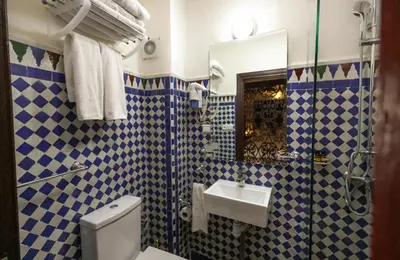 a bathroom with a toilet and a sink at Riad Anis Fes in Fès