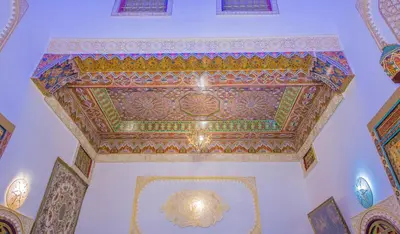 an ornate ceiling in a building with a painted ceiling at Riad Hayat Fes in Fès