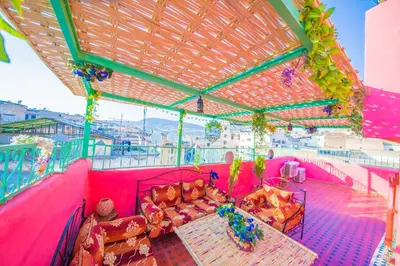 a pink room with couches on a ship at Riad Hayat Fes in Fès