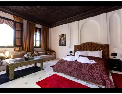 a bedroom with a bed with two stuffed animals on it at Palace with 2 villas and 2 swimming pools in Sidi Abdellah Ghiat in Had Abdallah Rhiat