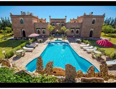 an estate with a swimming pool in front of a house at Palace with 2 villas and 2 swimming pools in Sidi Abdellah Ghiat in Had Abdallah Rhiat