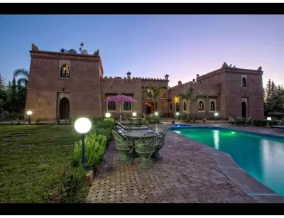 a large house with a swimming pool in front of it at Palace with 2 villas and 2 swimming pools in Sidi Abdellah Ghiat in Had Abdallah Rhiat