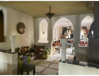 a living room with a couch and a table at Palace with 2 villas and 2 swimming pools in Sidi Abdellah Ghiat in Had Abdallah Rhiat