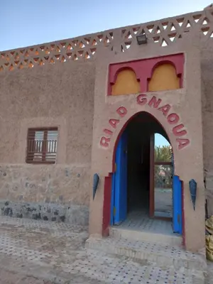 a building with a sign that reads funmoomed at Riad gnaoua khamlia in Merzouga