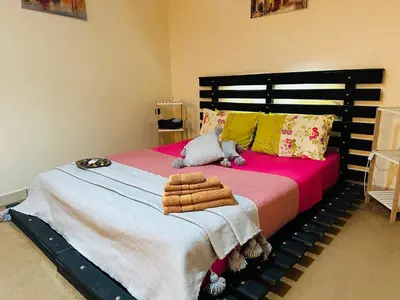 a bedroom with a large bed with towels on it at The Best Stop in Midelt