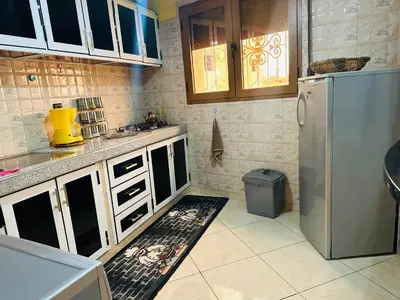 a kitchen with white cabinets and a refrigerator at The Best Stop in Midelt