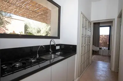 a kitchen with a sink and a mirror at Villa Mayaz - Piscine chauffée in Marrakech