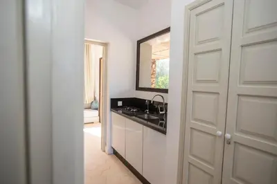 a bathroom with a sink and a mirror next to a door at Villa Mayaz - Piscine chauffée in Marrakech