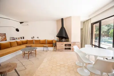 a living room with a couch and a table at Villa Mayaz - Piscine chauffée in Marrakech