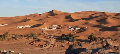 an aerial view of a desert with a group of houses at Abdo Luxury Camp with Heating in Merzouga