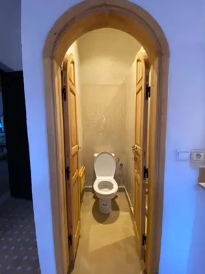 a bathroom with a toilet in an open door at Villa Atlas Secret in Ourika