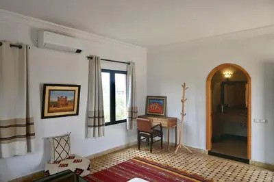 a living room with a desk and a window at Villa Atlas Secret in Ourika