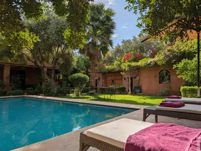 a swimming pool in a yard with a house at Villa Atlas Secret in Ourika