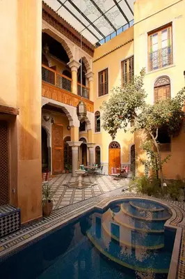a courtyard with a swimming pool in a building at Riad Layalina Fes in Fès