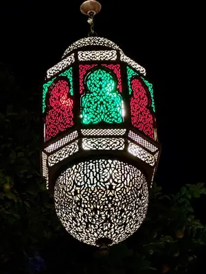 a christmas light hanging from a pole at night at Riad Layalina Fes in Fès