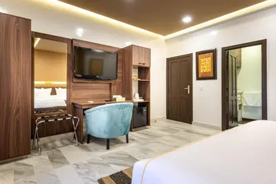 a hotel room with a bed and a television at The Lemonary Marrakech in Marrakech