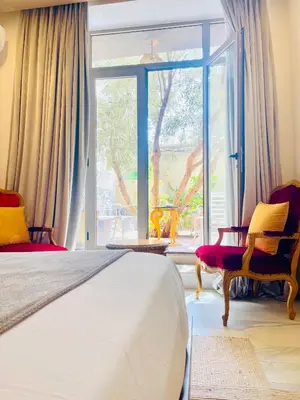 a bedroom with a bed and a large window at The Lemonary Marrakech in Marrakech