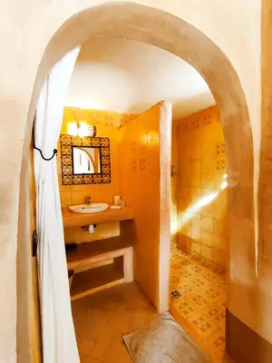 a bathroom with a sink and a shower at Maison d'hôtes Tigminou - Adults Only in Aït Ben Haddou