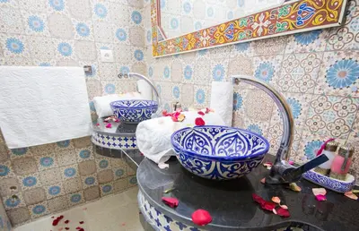 a bathroom with two blue and white bowls on a sink at Riad Mahrez in Fès