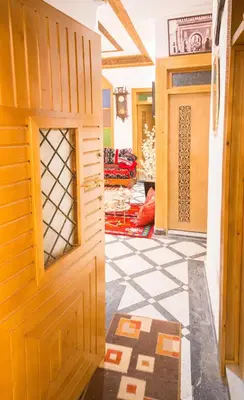 an open door in a room with a tile floor at Riad Mahrez in Fès