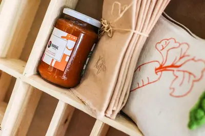 a jar of tomato sauce in a wooden box at Bakkal Farm Agrolodge in Marrakech