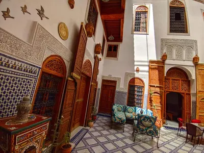 a room with a couch and chairs in a building at Riad Fès Center in Fès