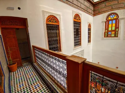 a staircase in a house with stained glass windows at Riad Fès Center in Fès