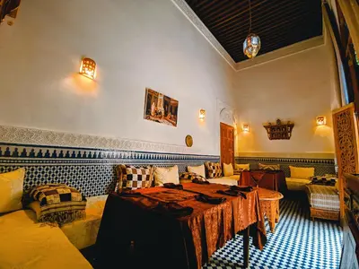 a living room with a table and a couch at Riad Fès Center in Fès