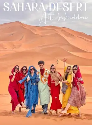 a group of people standing in the desert at Merzouga Nice luxury Camp in Merzouga