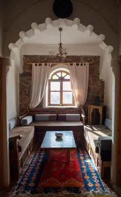 a living room with a couch and a table at Afoulki Ecotourism Guest House in Telouet
