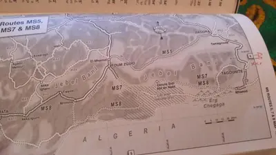 a map of algeria on a book at Auberge Dinosaur Kem Kem in Tafraoute Sidi Ali