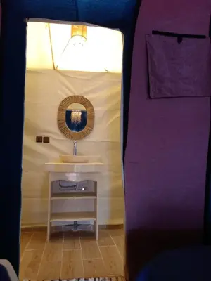 a bathroom with a sink and a mirror at Merzouga Ana luxury Camp in Merzouga