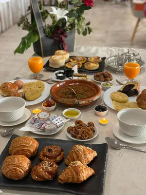 a table with many different types of pastries on it at Eventi Club by cité des sports adarissa in Fès