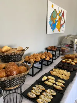a table filled with lots of different types of pastries at Eventi Club by cité des sports adarissa in Fès