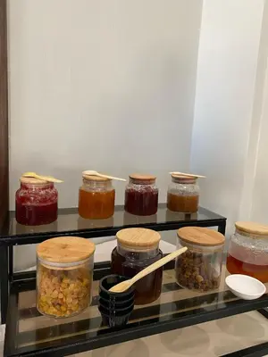 a refrigerator filled with jars of jams and jelly at Eventi Club by cité des sports adarissa in Fès
