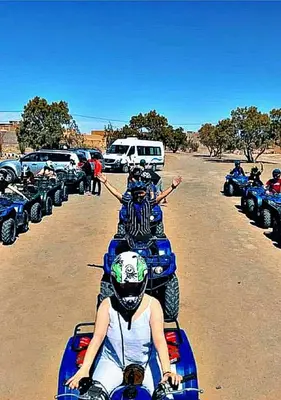 a group of people on a motorcycle in the desert at Merzouga apartments holiday in Merzouga