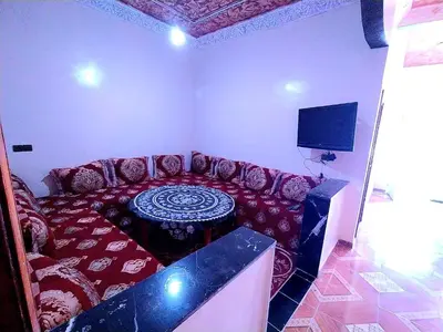 a living room with a couch and a tv at Merzouga apartments holiday in Merzouga