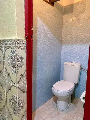 a bathroom with a white toilet in a room at Dar Relax Hostel, Gorges de Todra in Tinerhir