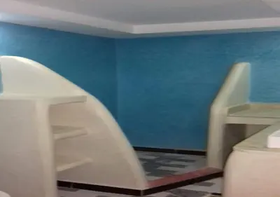a bathroom with a blue wall and a white staircase at Kasr Tin Hinane in Merzouga
