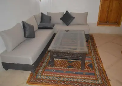 a living room with a couch and a coffee table at Kasr Tin Hinane in Merzouga