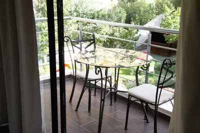 a balcony with a table and chairs on a porch at La Perle de l'Ourika in Ourika