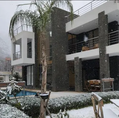 a building with a swimming pool in the snow at La Perle de l'Ourika in Ourika