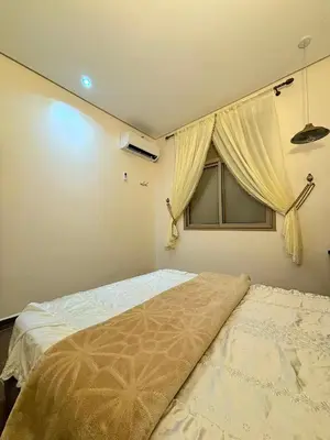 a bedroom with a bed and a window at Issli appartment climatisé hiver et été in Azrou