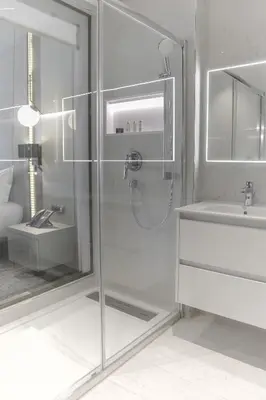 a bathroom with a glass shower and a sink at Oriental Palace by Agora Complex in Taza