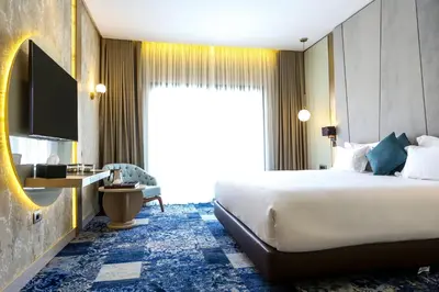 a hotel room with a large bed and a television at Oriental Palace by Agora Complex in Taza