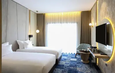a hotel room with two beds and a television at Oriental Palace by Agora Complex in Taza