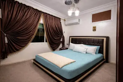 a bedroom with a bed and a window at Residence Bouanane B in Fès